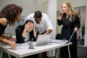 Business team struggling with disorganized technology and workflow in office environment